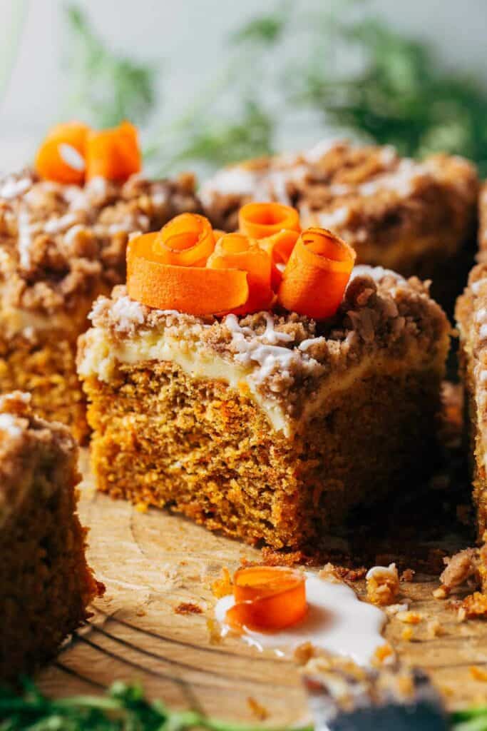 close up on a slice of carrot coffee cake baked with a layer of cream cheese