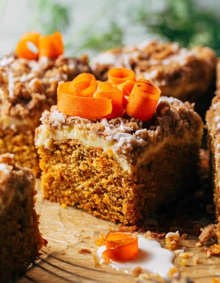 close up on a slice of carrot coffee cake baked with a layer of cream cheese