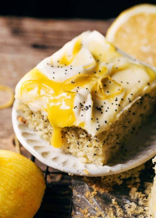 a slice of lemon poppy seed cake topped with lemon curd
