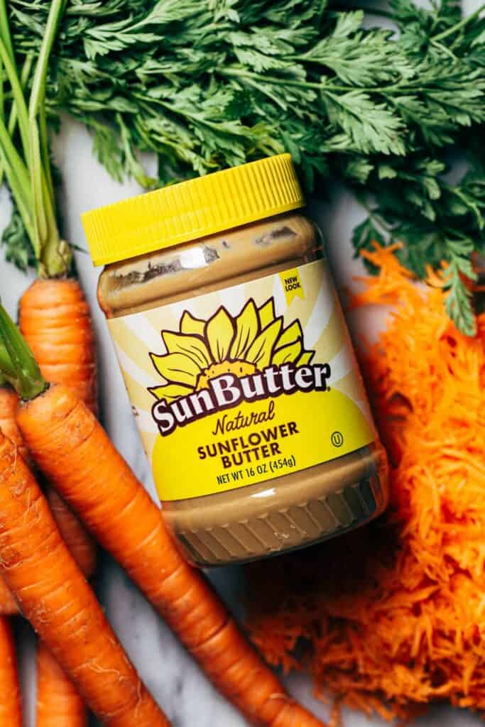 a jar of sunbutter with carrots