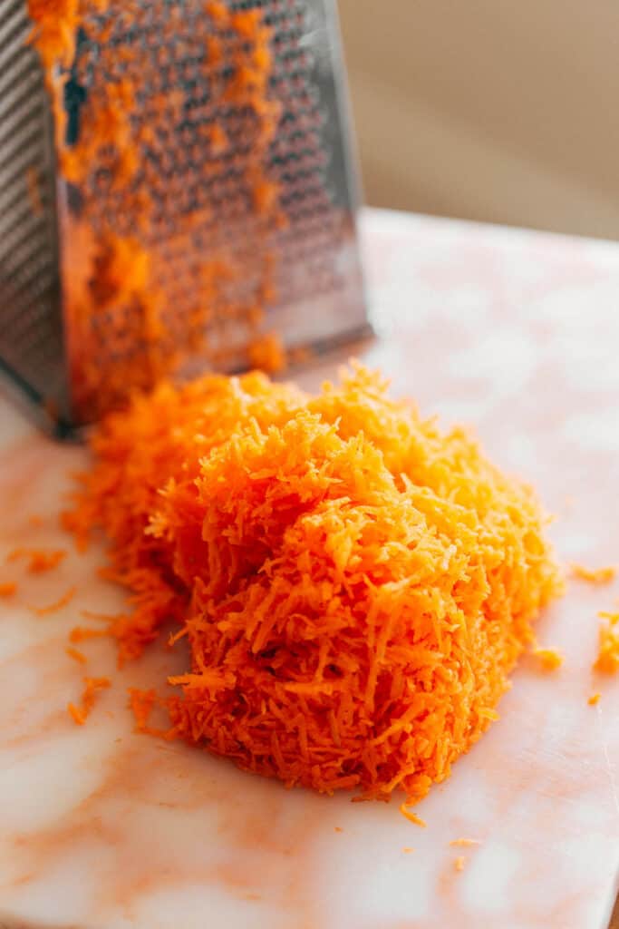 hand grated carrots on a cutting board