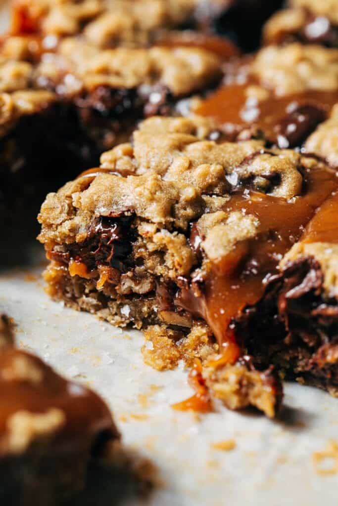 close up on a slice of caramel oatmeal cookie bar