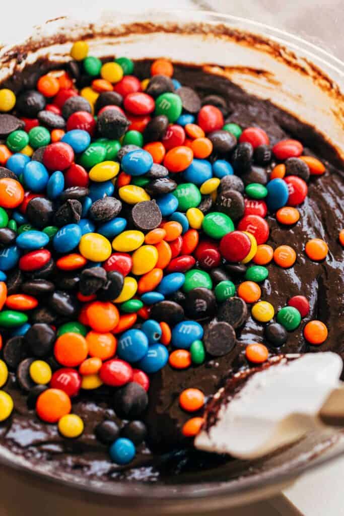 a bowl of brownie batter with m&m candies
