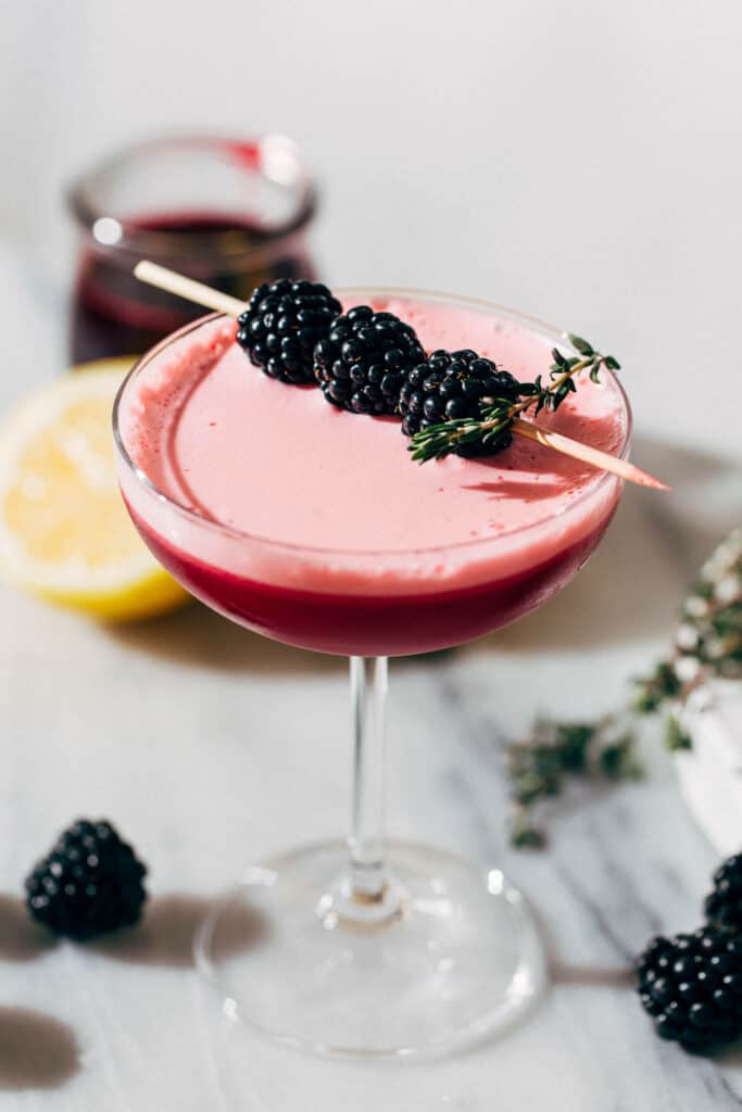 a vodka sour with blackberry garnish