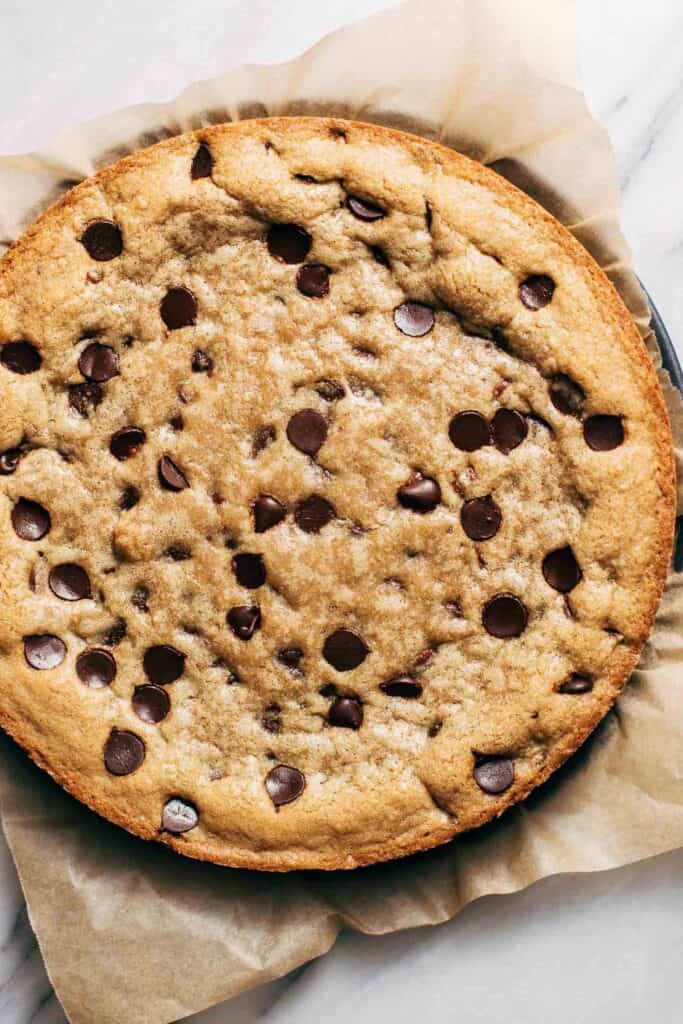 a freshly baked cookie cake before frosting