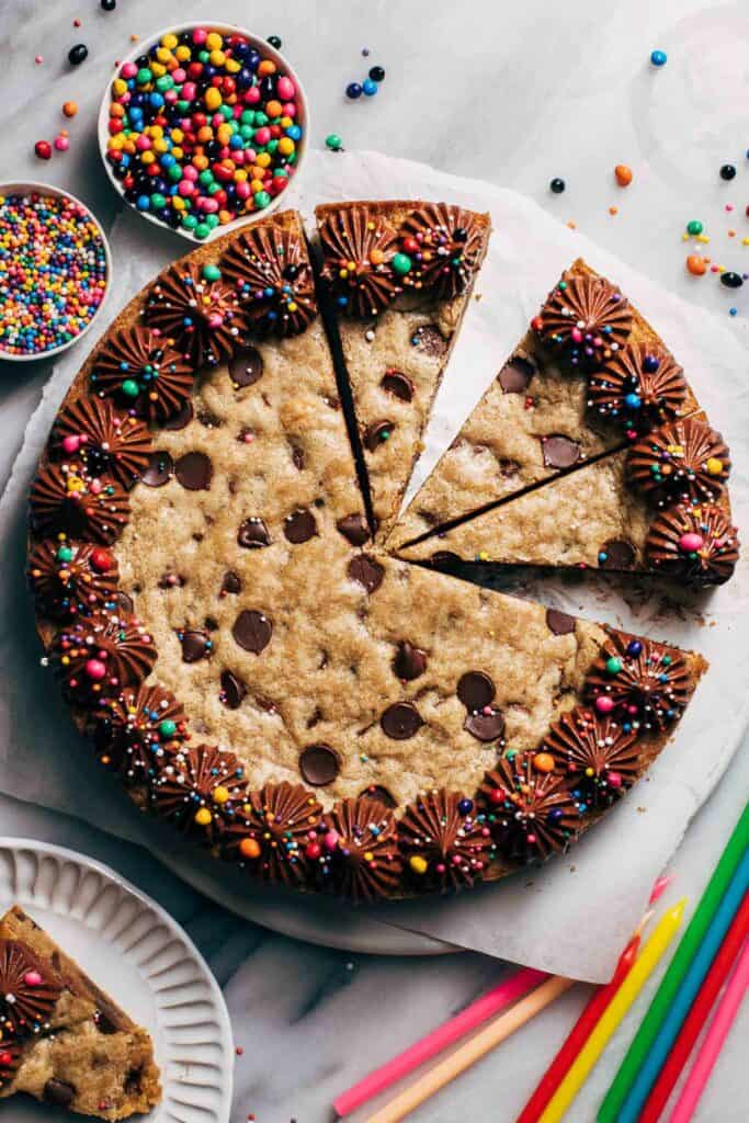 the top of a sliced cookie cake with chocolate frosting