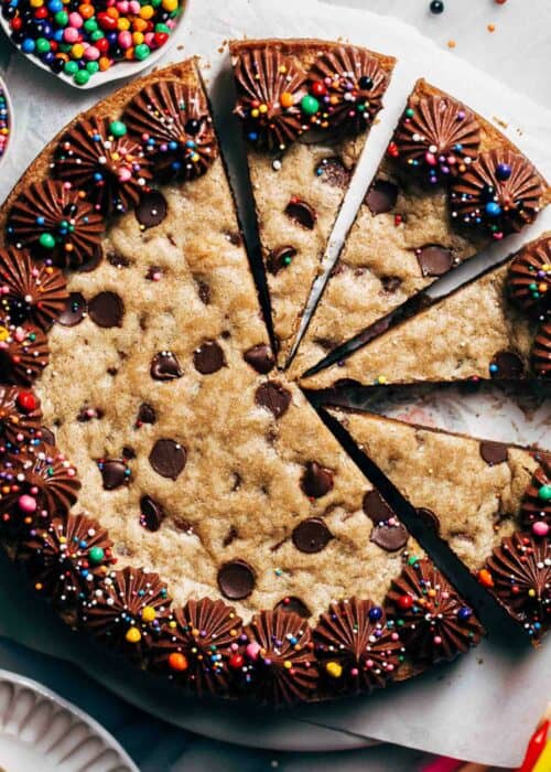 close up on the top of a sliced chocolate chip cookie cake