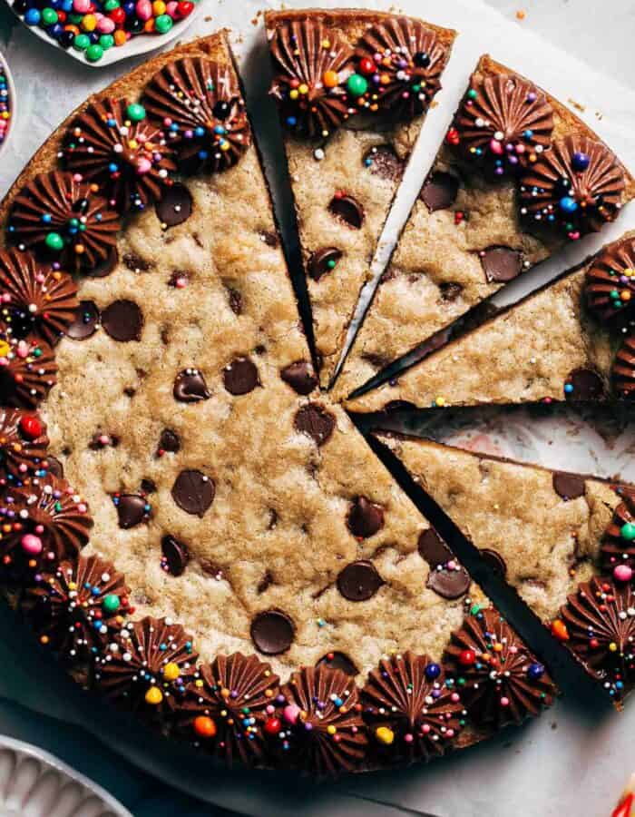 close up on the top of a sliced chocolate chip cookie cake
