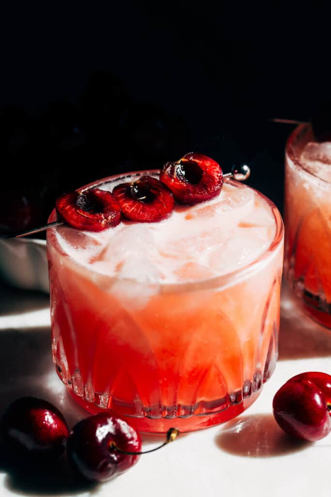 a cherry Italian margarita made with amaretto and topped with fresh cherries