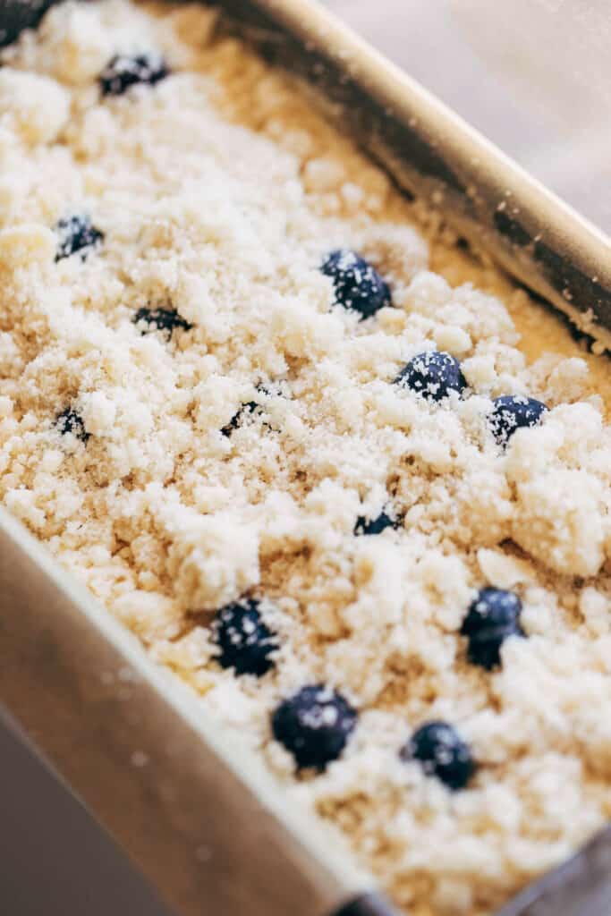 lemon blueberry loaf cake batter in a baking pan