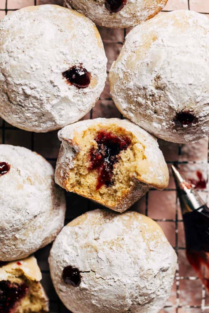 a bite taken from a jelly filled donut muffin