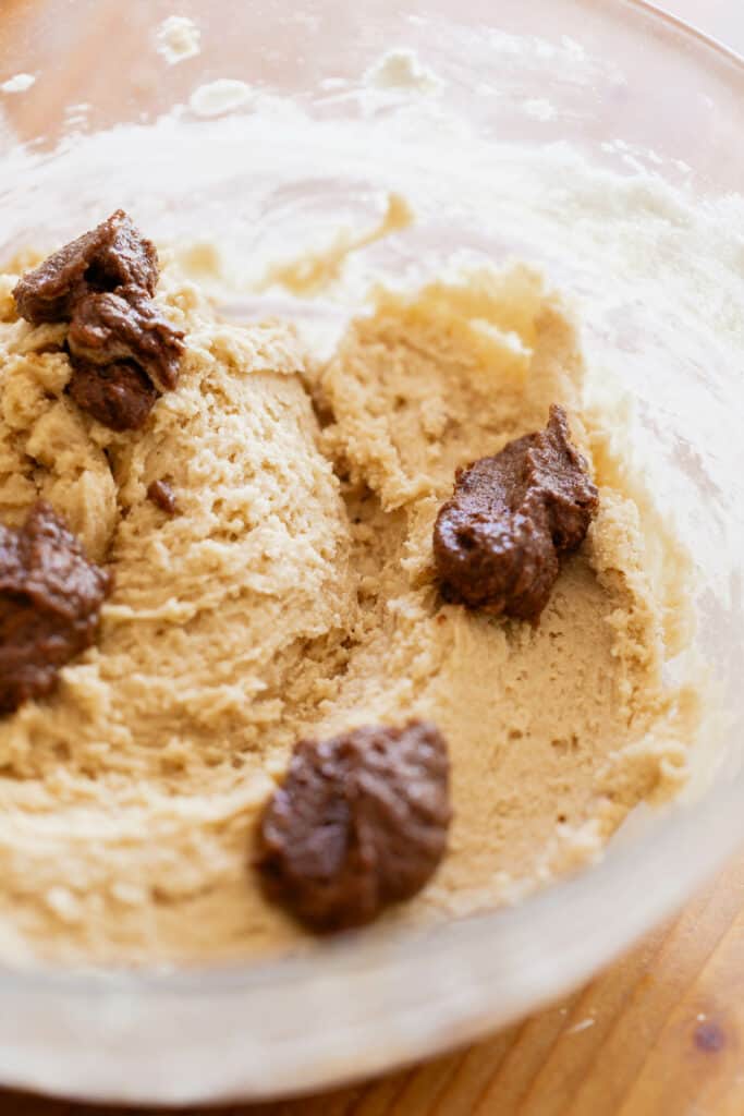 a bowl of maple cookie dough with scoops of spiced maple butter