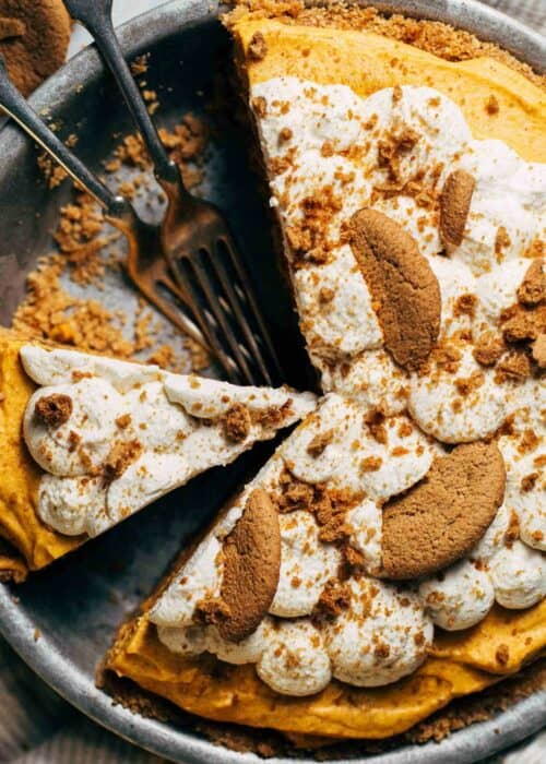 the top of a no bake pumpkin pie with whipped cream and gingersnap cookies