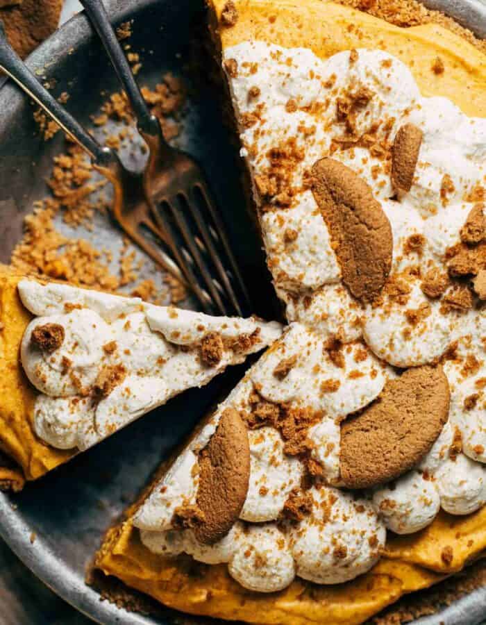 the top of a no bake pumpkin pie with whipped cream and gingersnap cookies