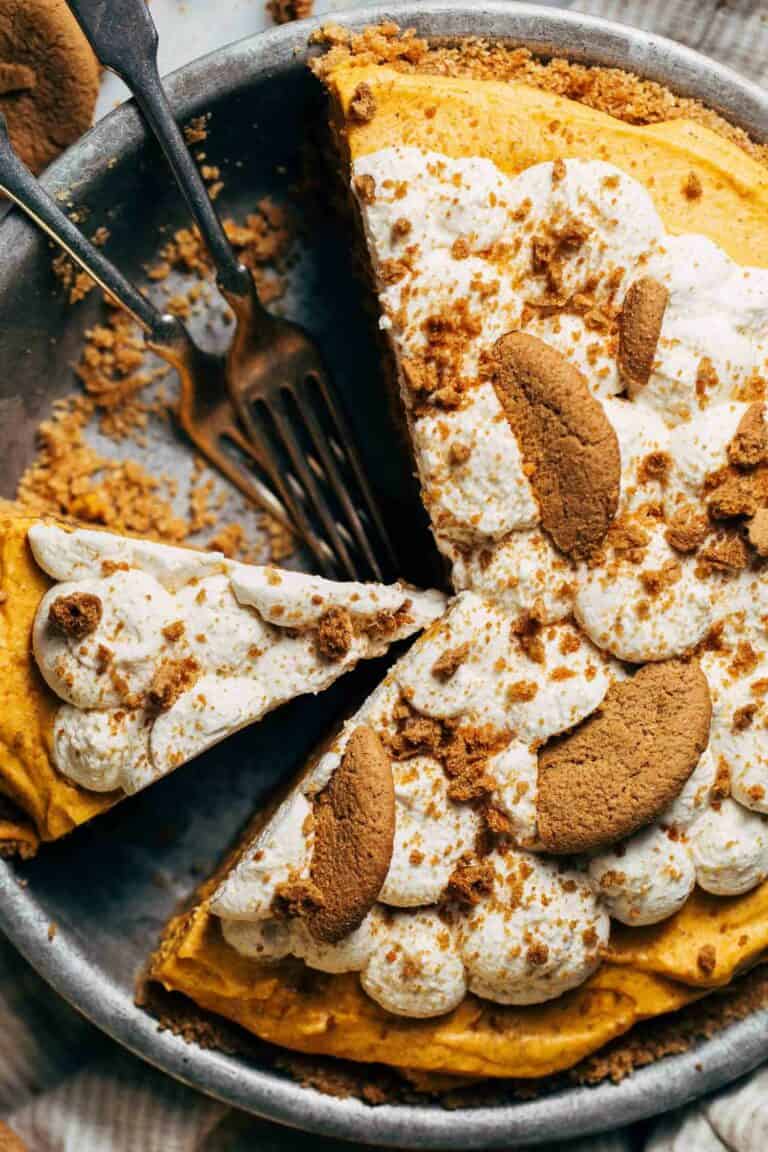 the top of a no bake pumpkin pie with whipped cream and gingersnap cookies