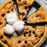 close up on the top of a sliced cookie pie with ice cream