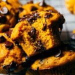 a bite from a moist pumpkin chocolate chip muffin