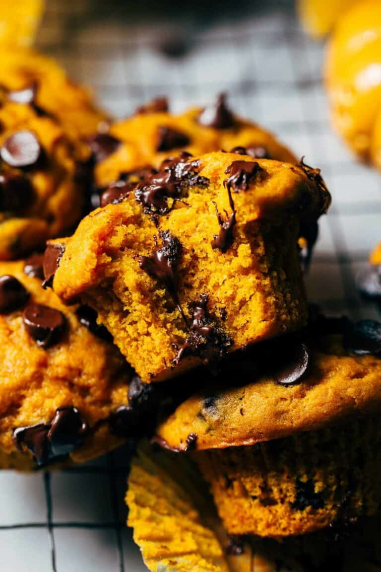 a bite from a moist pumpkin chocolate chip muffin