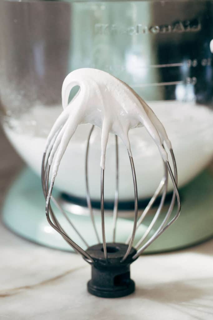 whipped meringue on the tip of a whisk