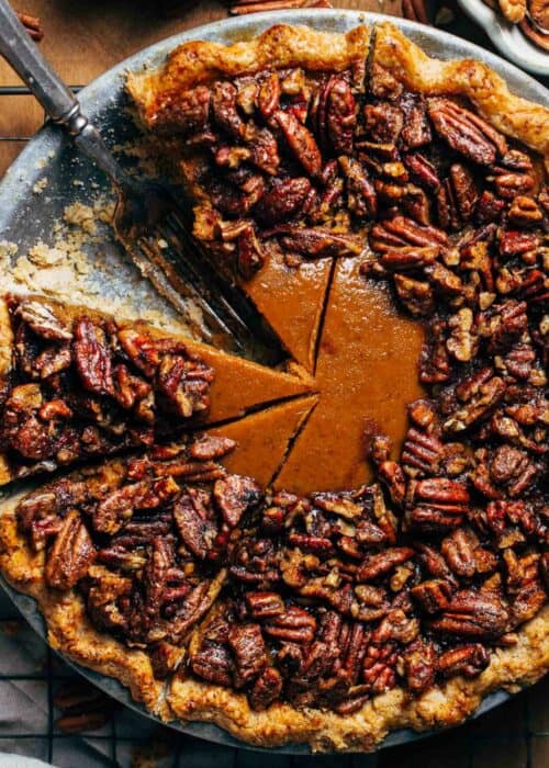a sliced pumpkin pie topped with candied pecans