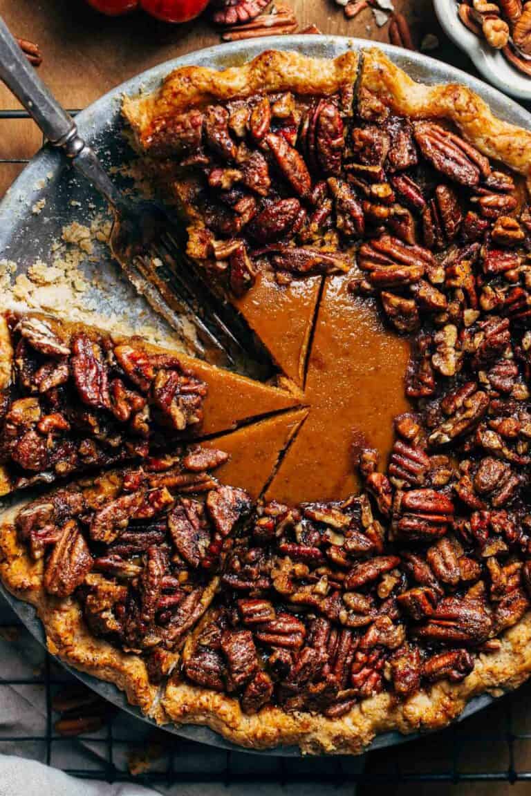 a sliced pumpkin pie topped with candied pecans