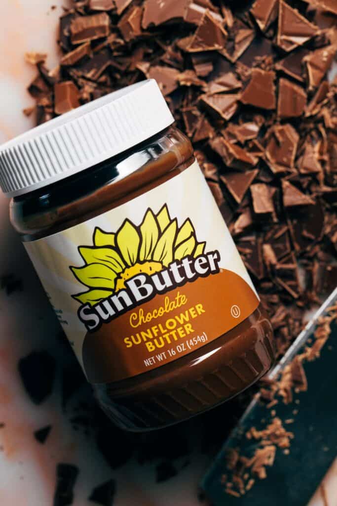 a jar of chocolate sunbutter with chopped chocolate pieces