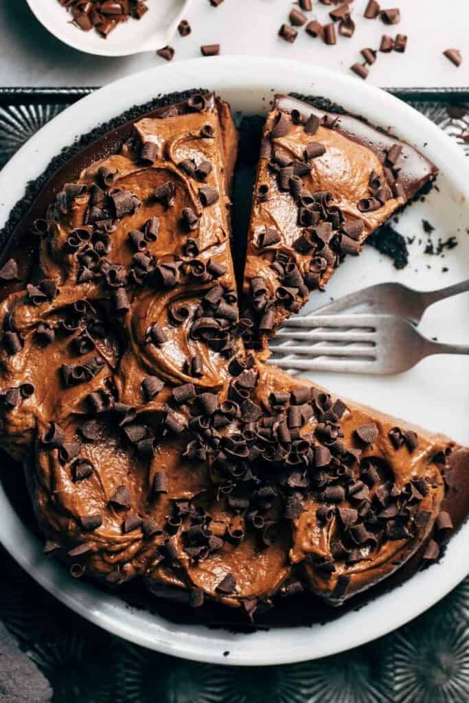 the top of a chocolate cream pie topped with chocolate curls