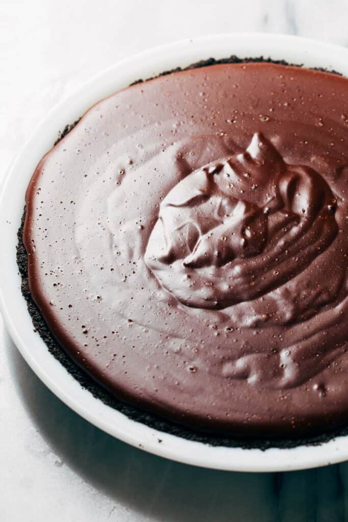a chocolate cookie crust with chocolate pudding filling poured inside