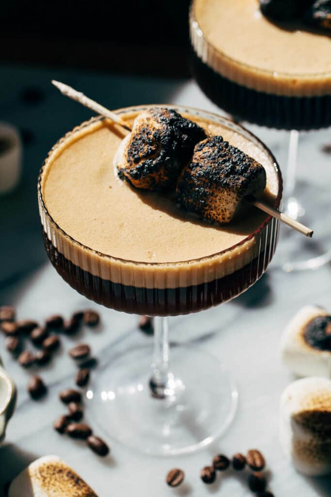 toasted marshmallows scewered on top of an espresso martini