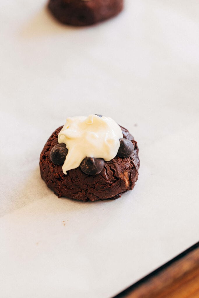 white chocolate on top of brownie cookie dough