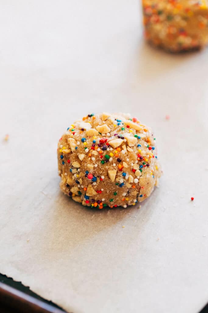 a peanut butter cookie dough ball on a baking pan