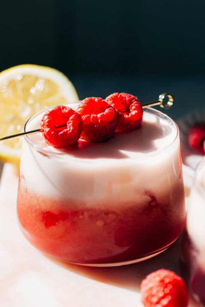 a raspberry mocktail with raspberry garnishes
