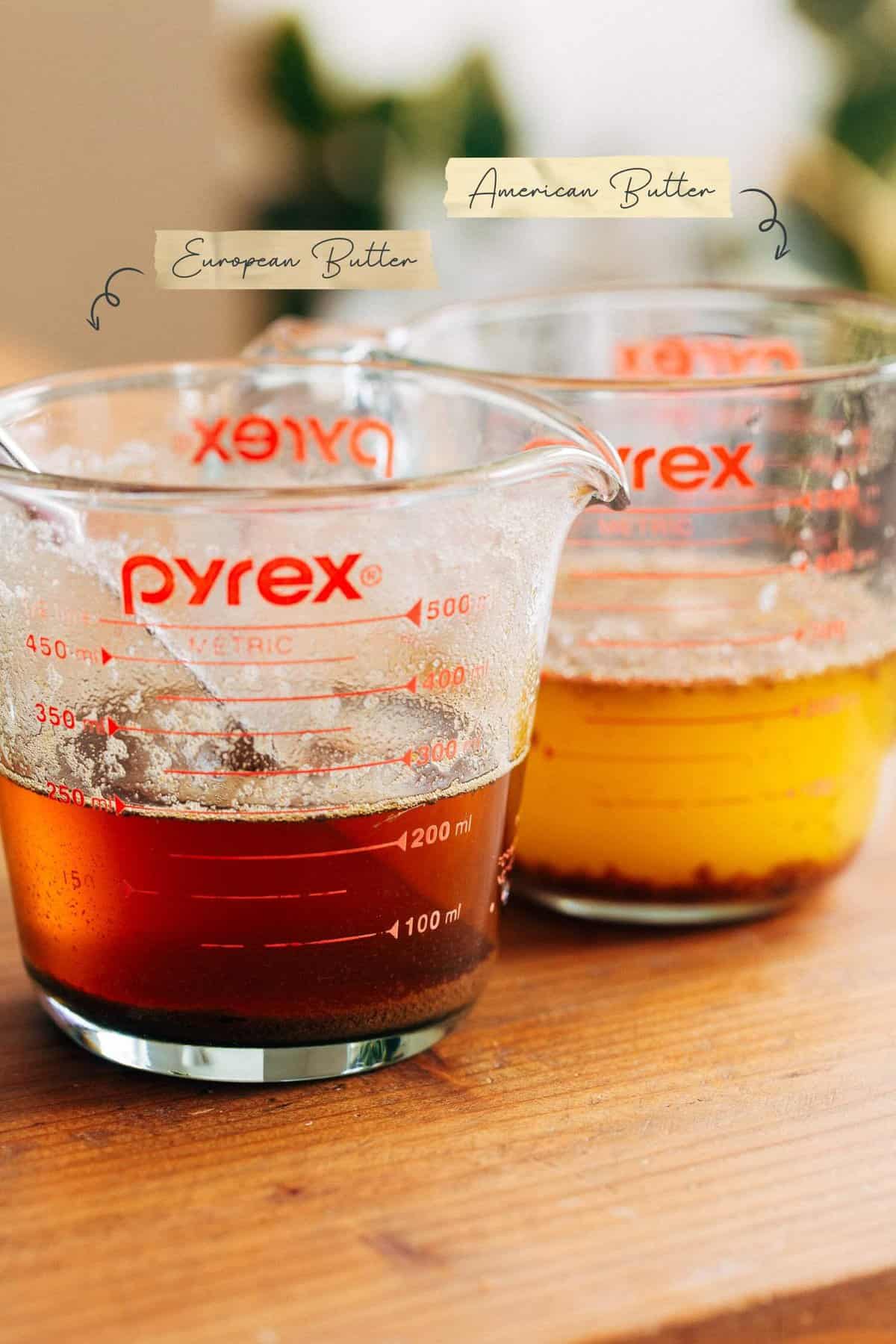 glass pyrex measuring cup containing melted european butter next to another glass pyrex measuring cup containing melted american butter