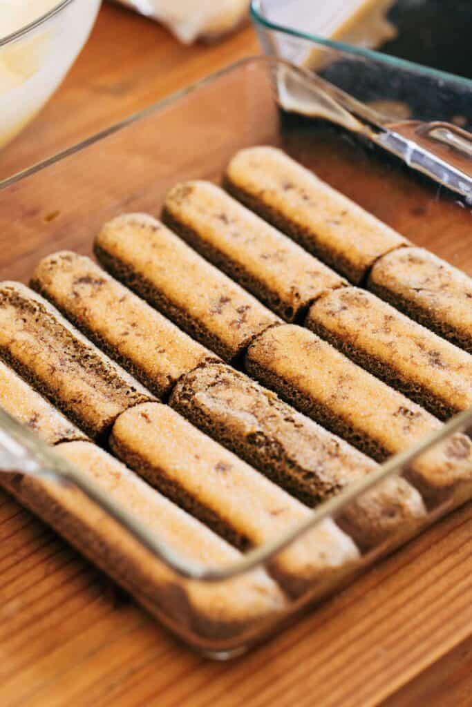 coffee soaked lady fingers in a baking pan