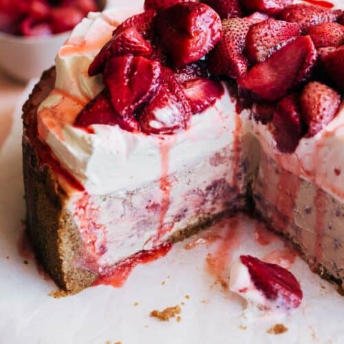 inside a sliced strawberry cheesecake piled with fresh strawberries