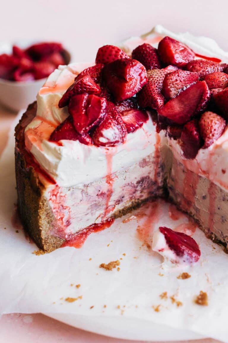 inside a sliced strawberry cheesecake piled with fresh strawberries