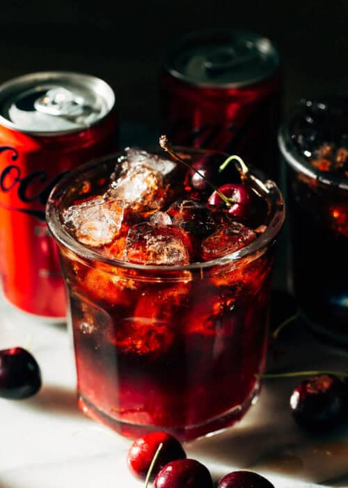 a cherry coke margarita with cans of soda