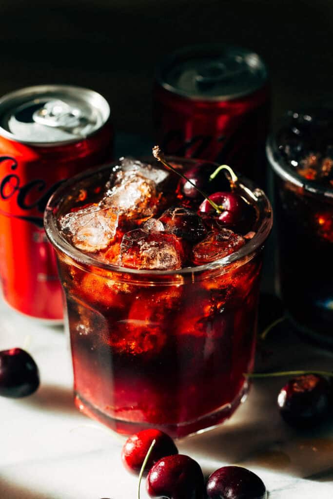 a cherry coke margarita with cans of soda