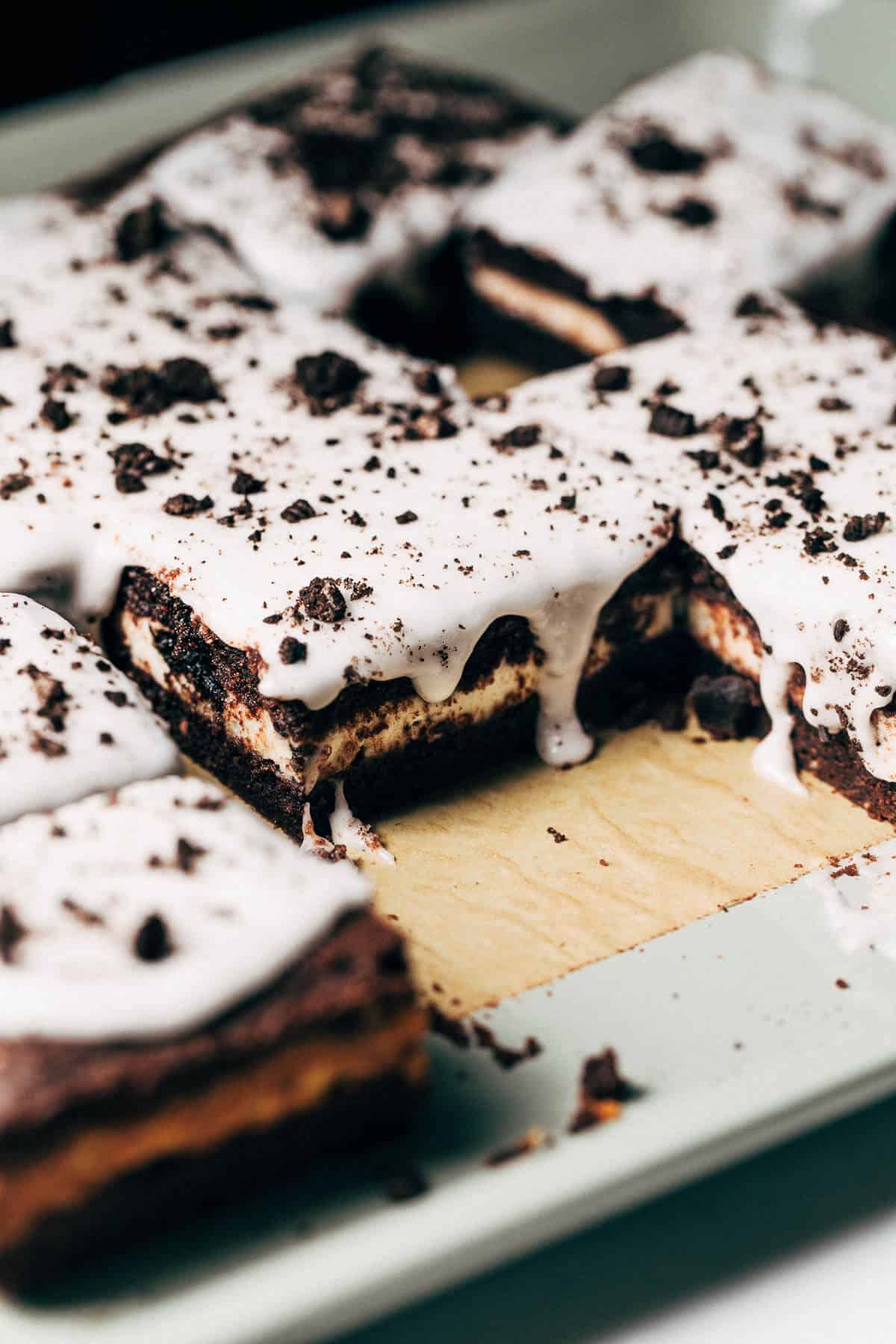 close up on sliced cookies and cream pop tart bars with one bar removed from pan