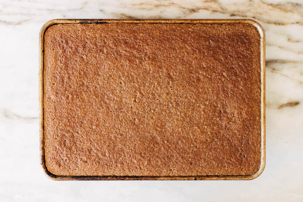 overhead process shot of baked vanilla latte cake in a sheet pan