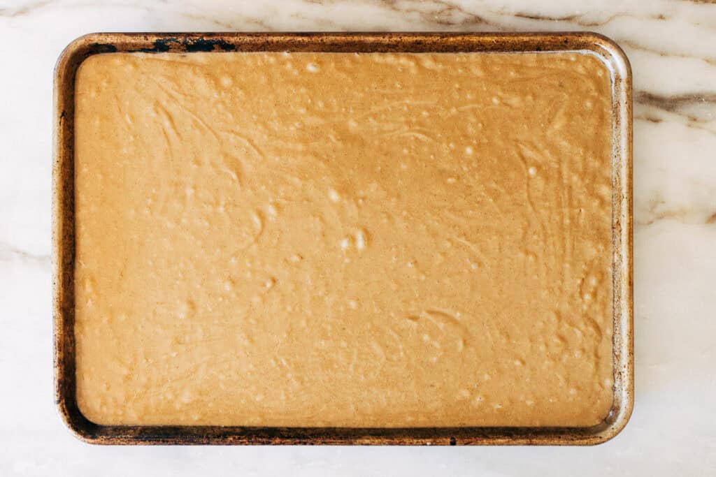 overhead process shot of vanilla latte cake batter in a sheet pan