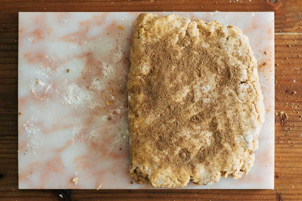 process shot of folded scone dough with chai spice