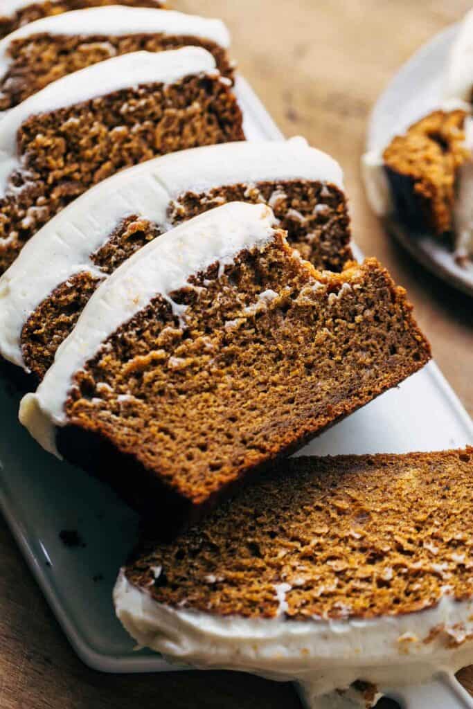 bite shot of cream cheese frosted pumpkin bread