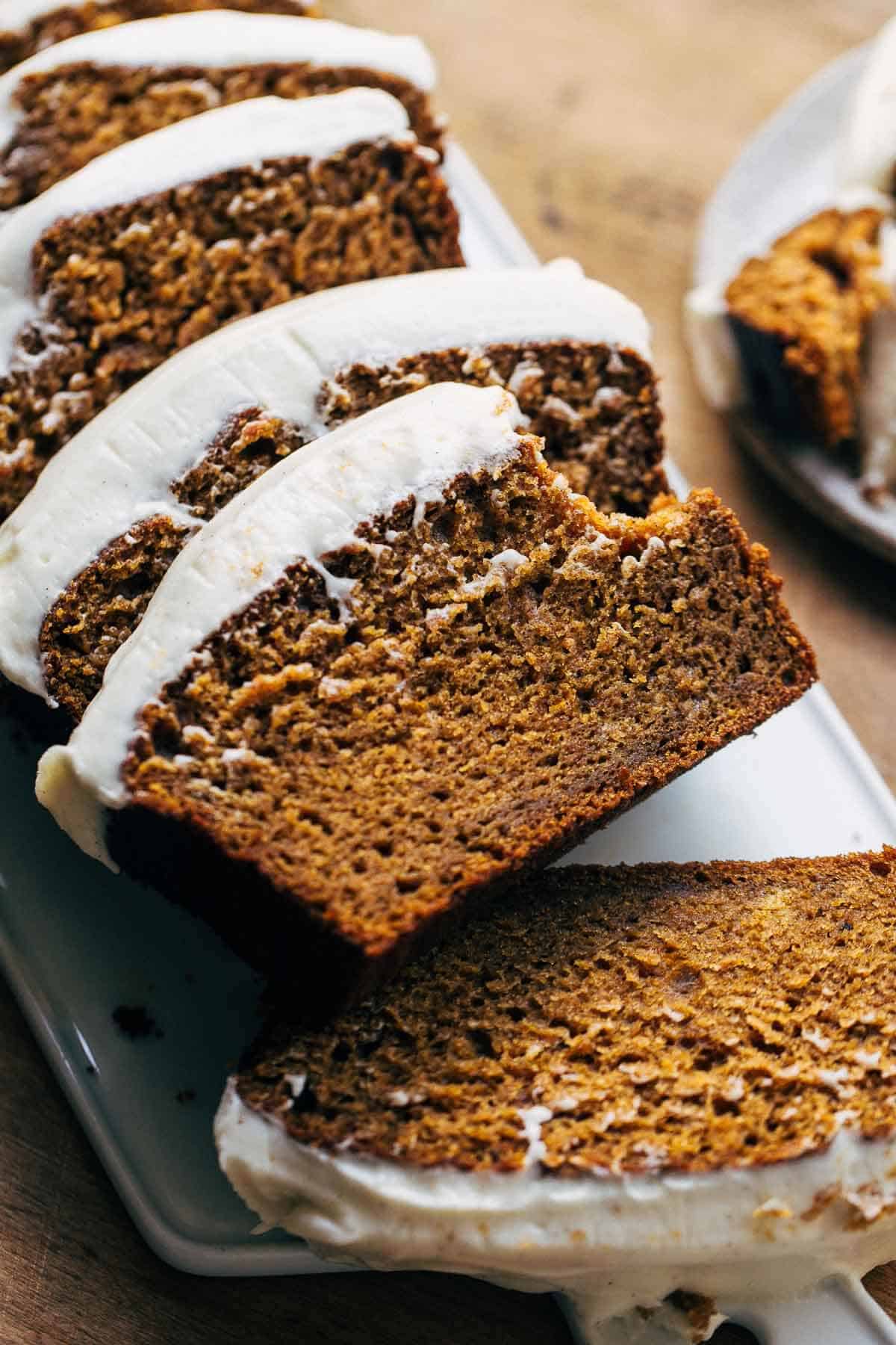 bite shot of cream cheese frosted pumpkin bread