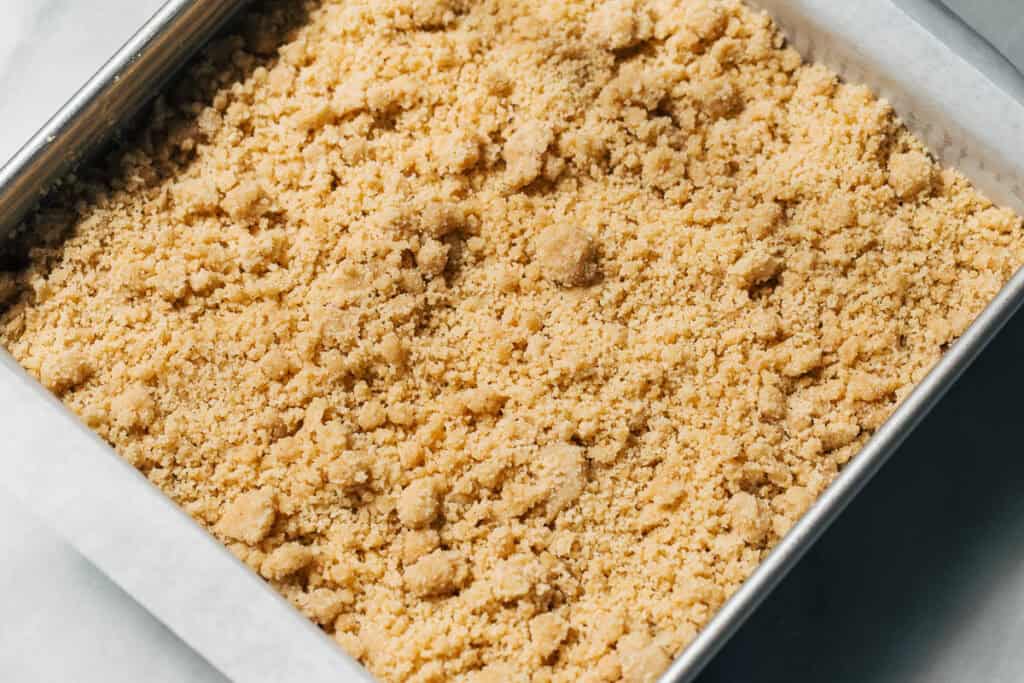 raw crumble on top of coffee cake batter