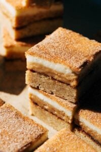 close up on stack of snickerdoodle cheesecake bars