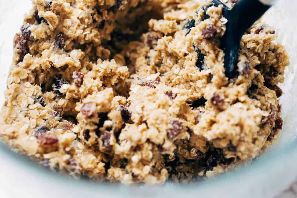 process shot of oatmeal raisin cookie dough in mixing bowl