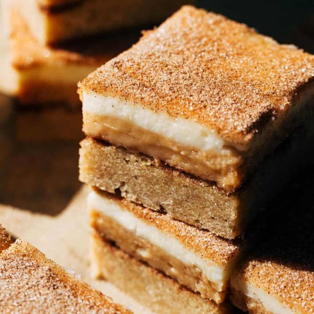 close up on stack of snickerdoodle cheesecake bars