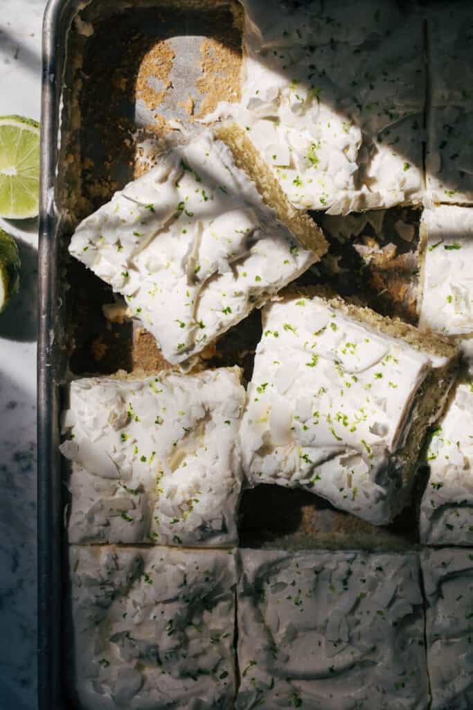 coconut lime sheet cake sliced in the pan