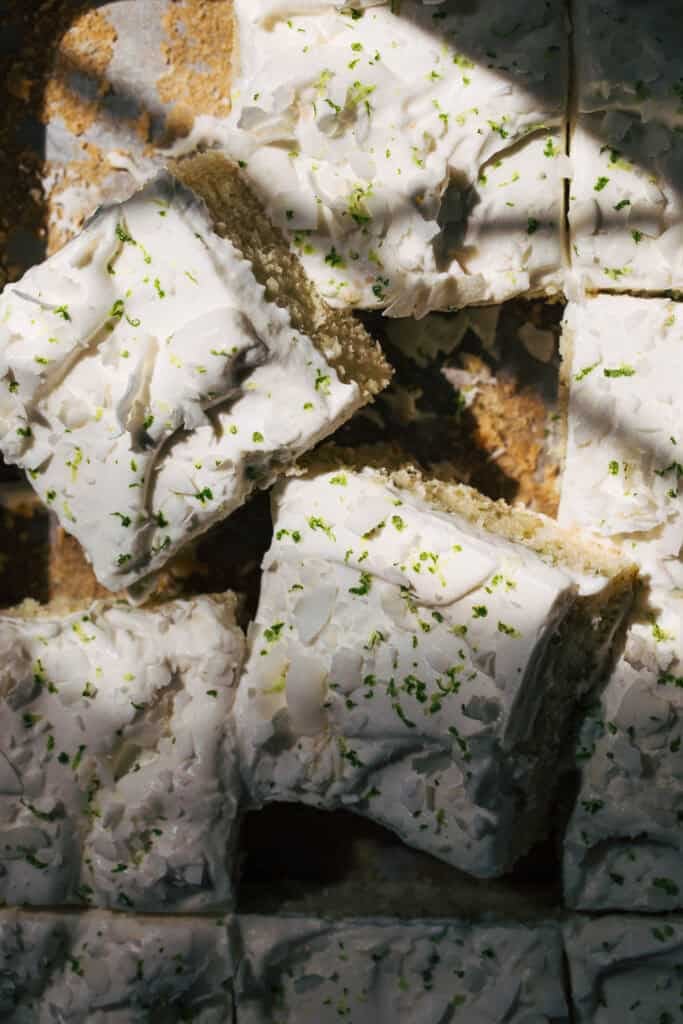 the top of sliced coconut lime sheet cake